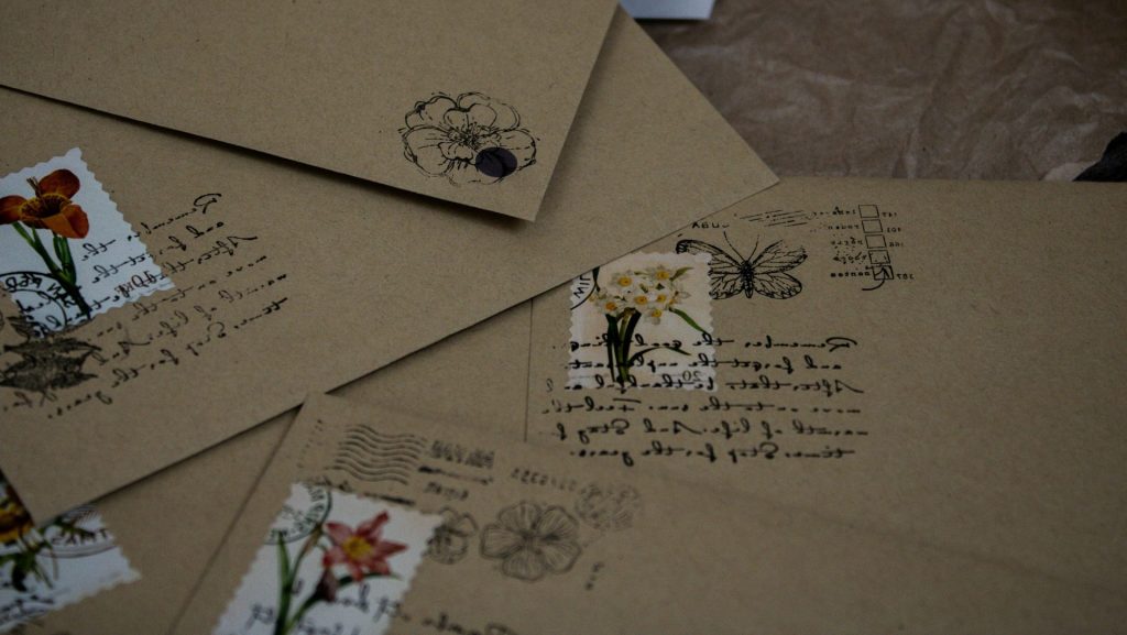 a pile of envelopes with flowers on them