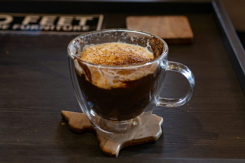 A cup of coffee sitting on top of a wooden table